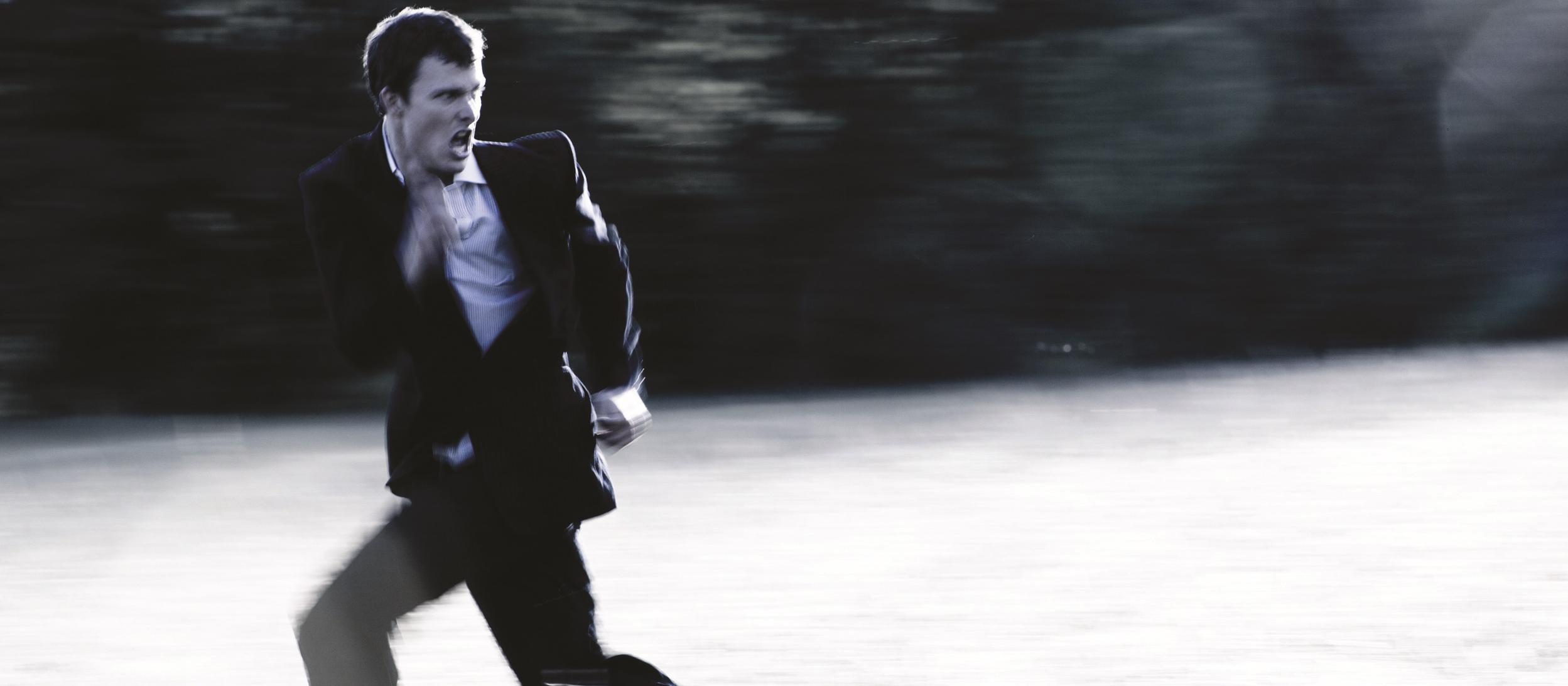 business man running, fear, escape