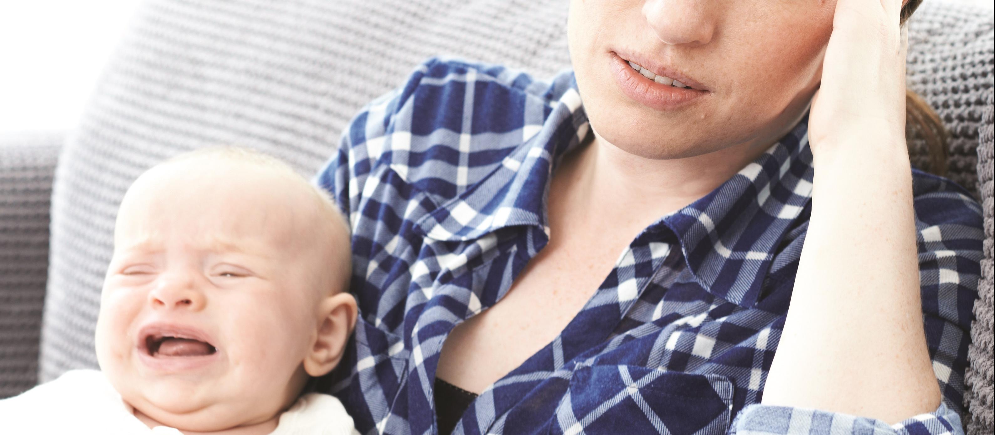 Harrassed young mother and baby
