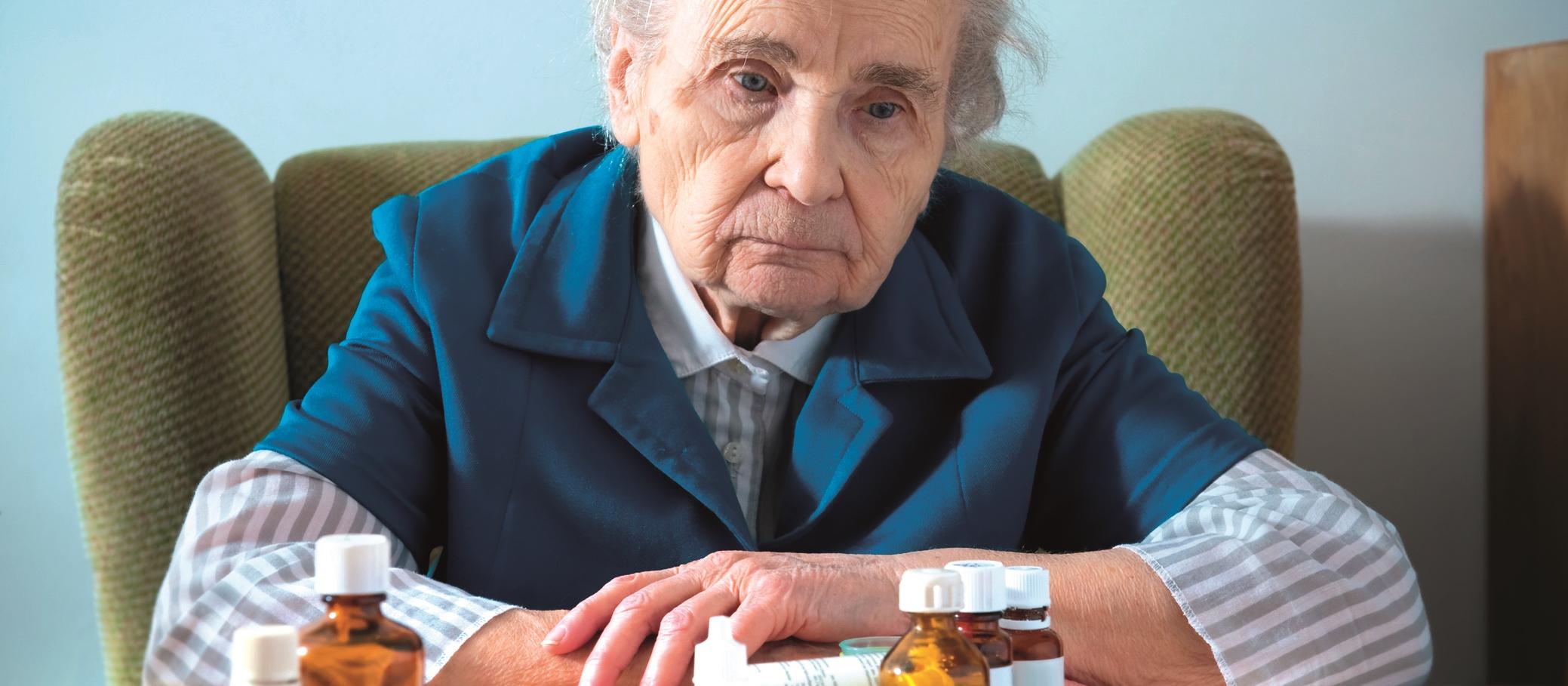 Elderly woman with pills