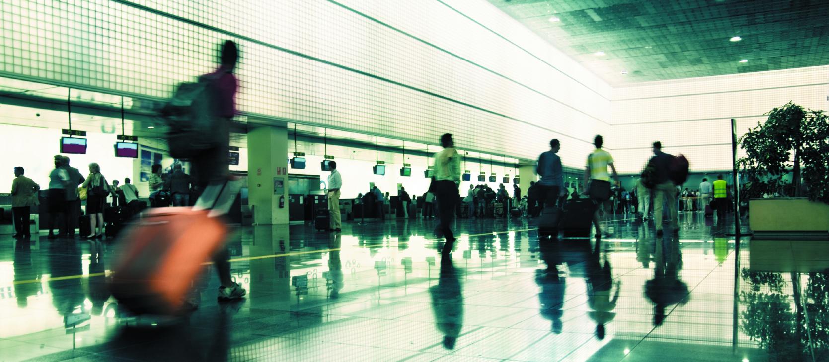 Travellers in busy airport
