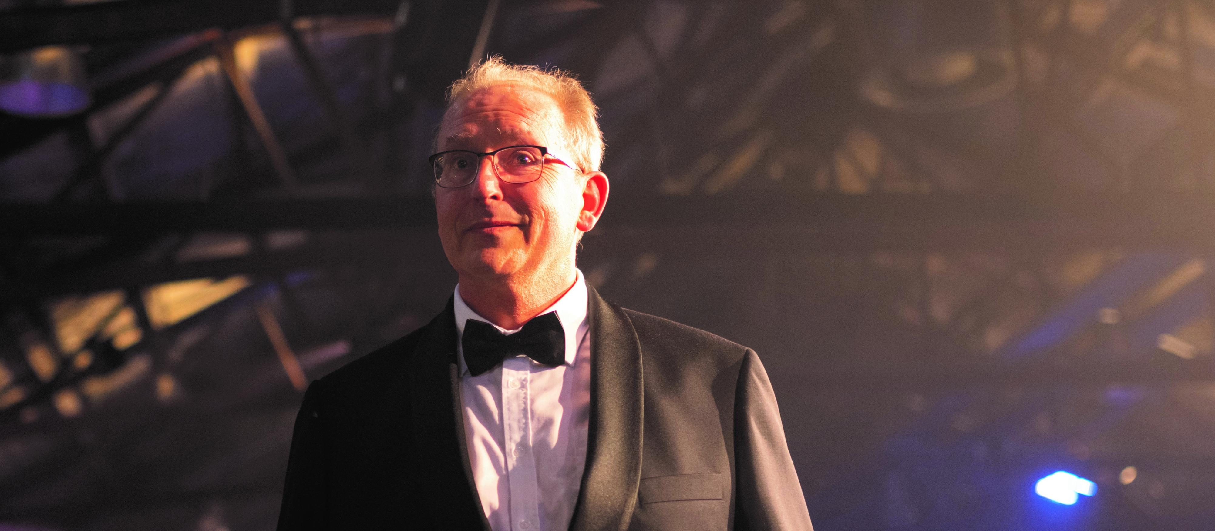Adrian Tucker walking to the stage