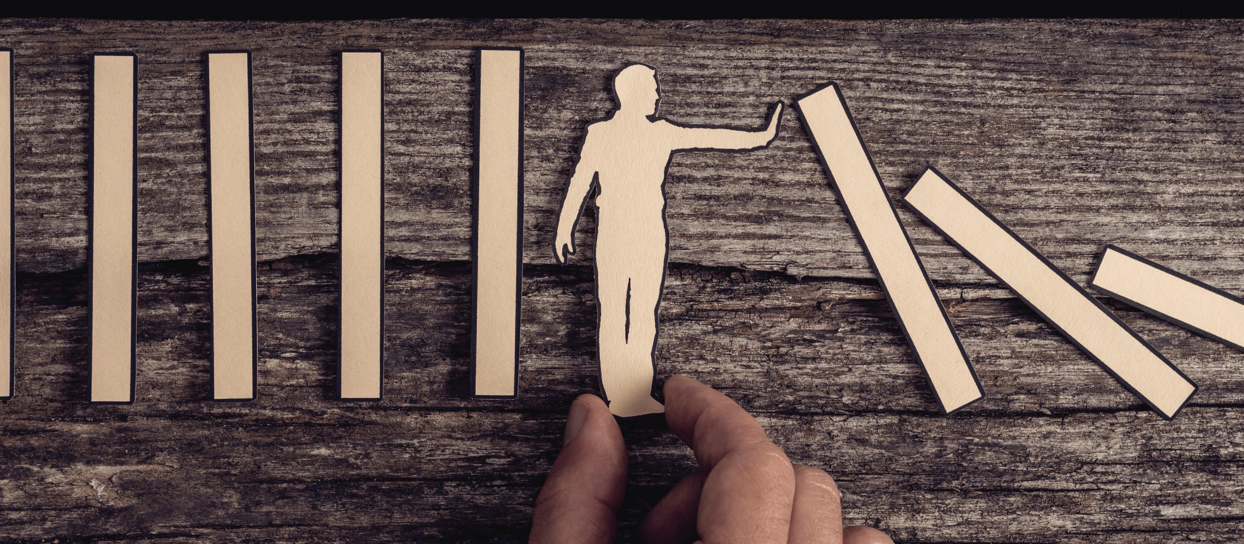 Little figure stopping domino effect