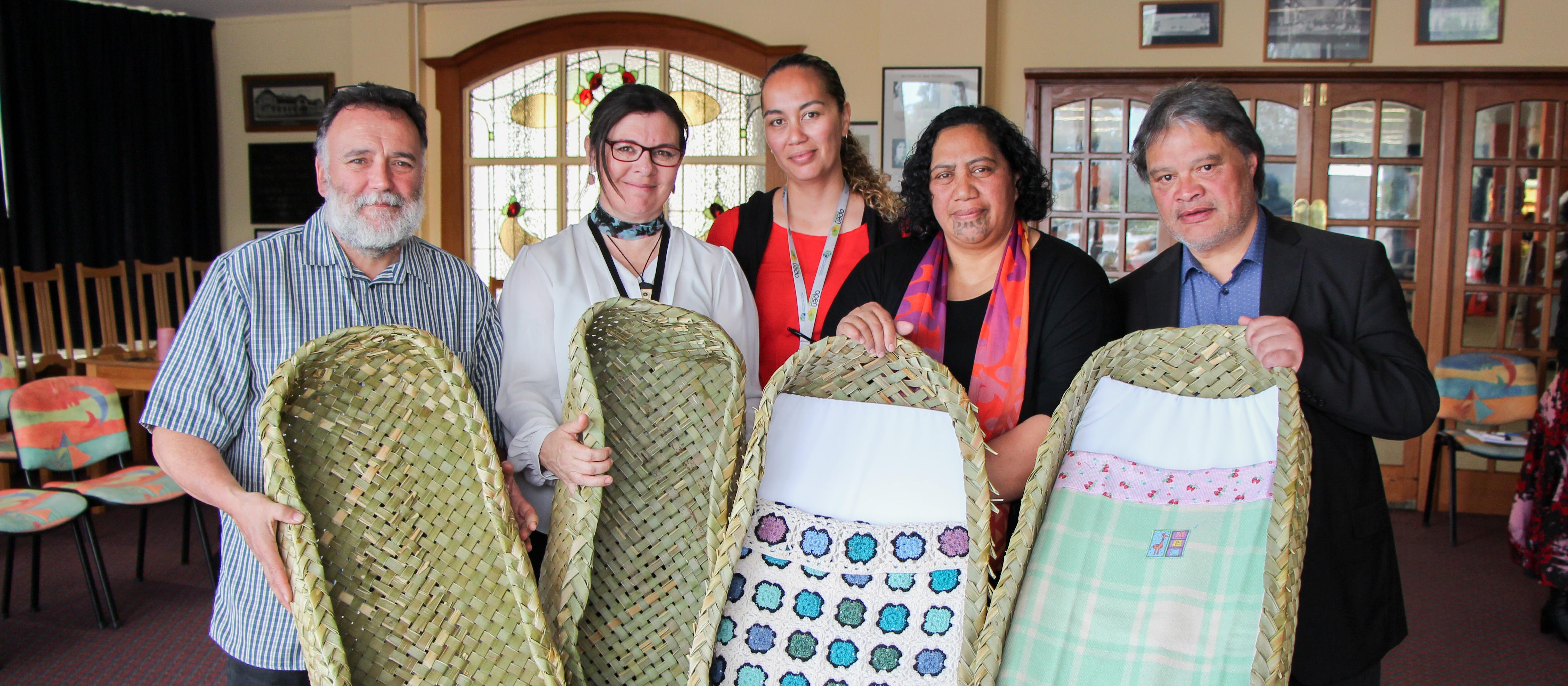 Dr Ruakere Hond, Rachael Peek (Taranaki DHB associate director of Midwifery), Grace Maha (Taranaki DHB midwife and SUDI prevention coordinator), Puhi and Philip Nuku (local weavers)