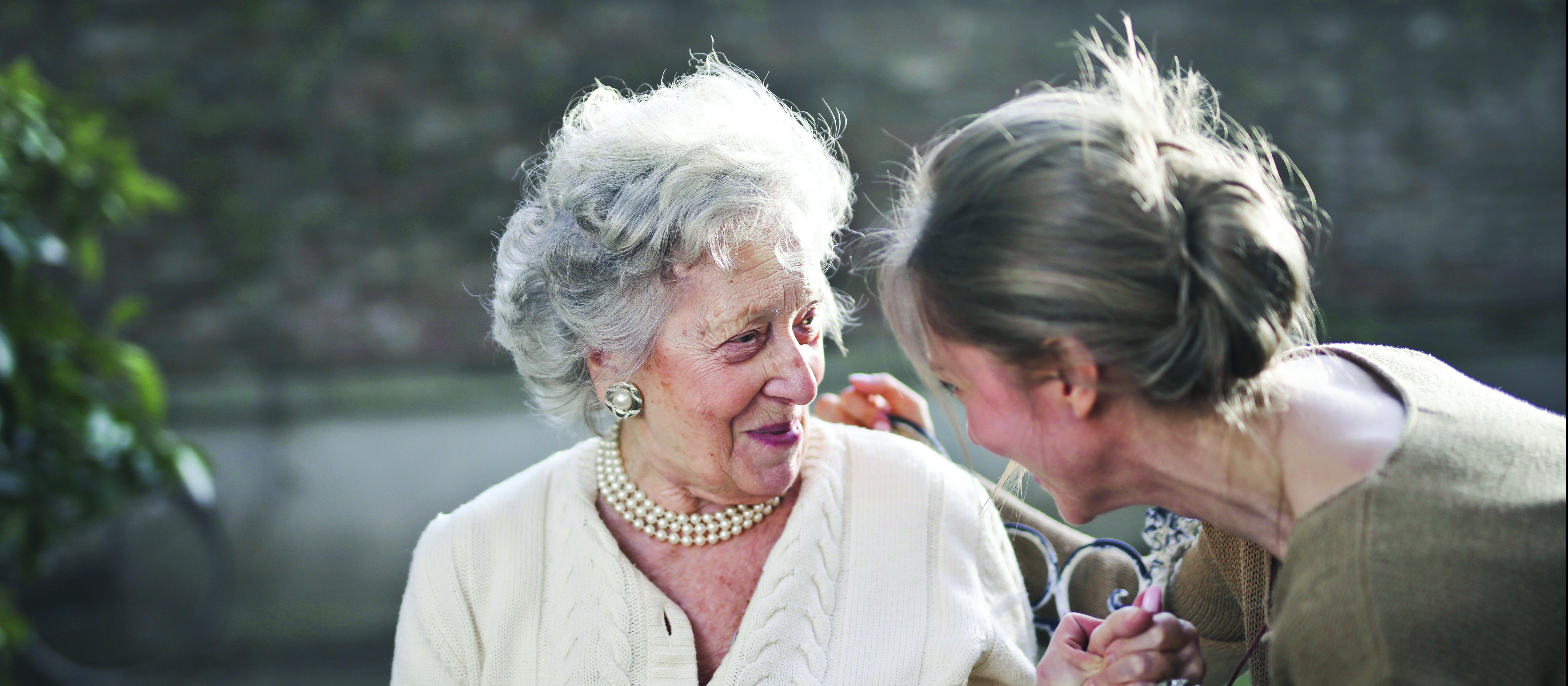 Older woman talking with younger woman