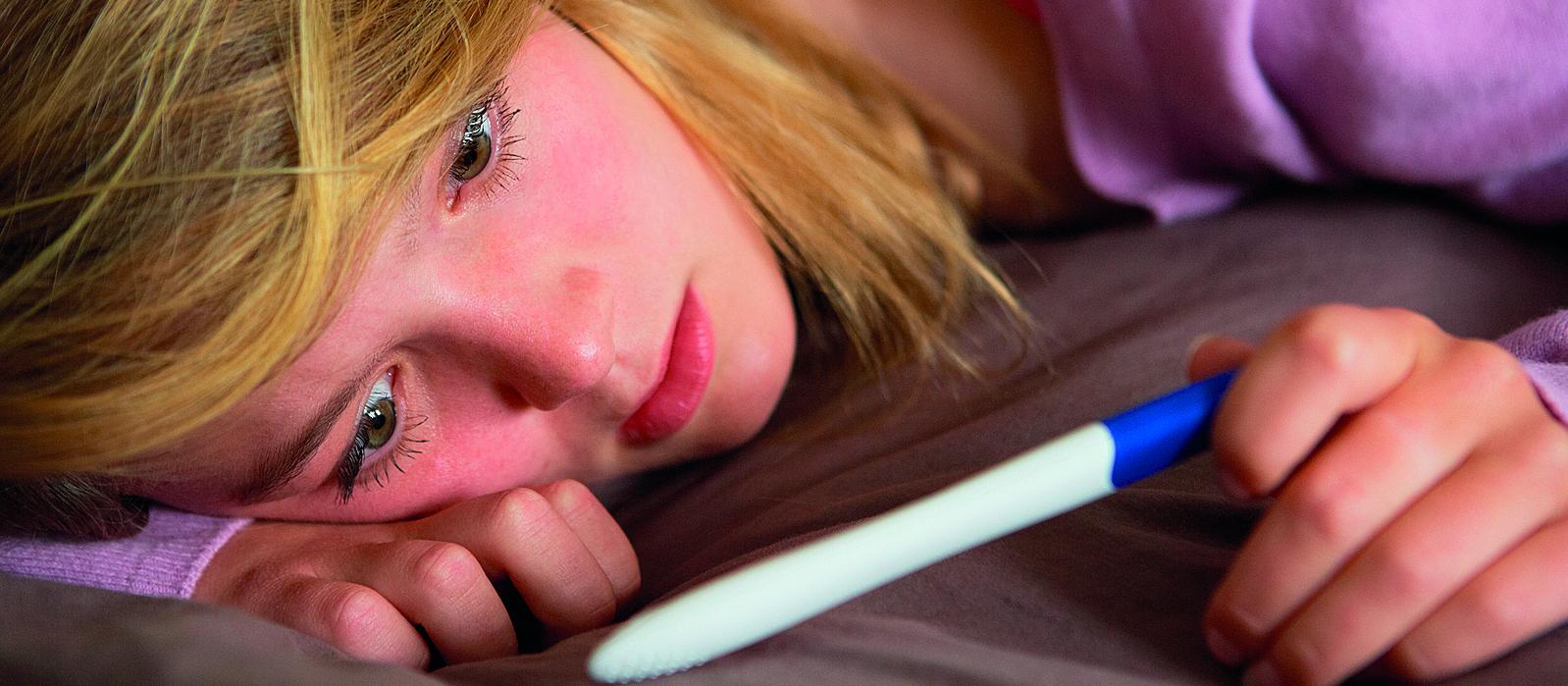 Teenage girl with a pregnancy test