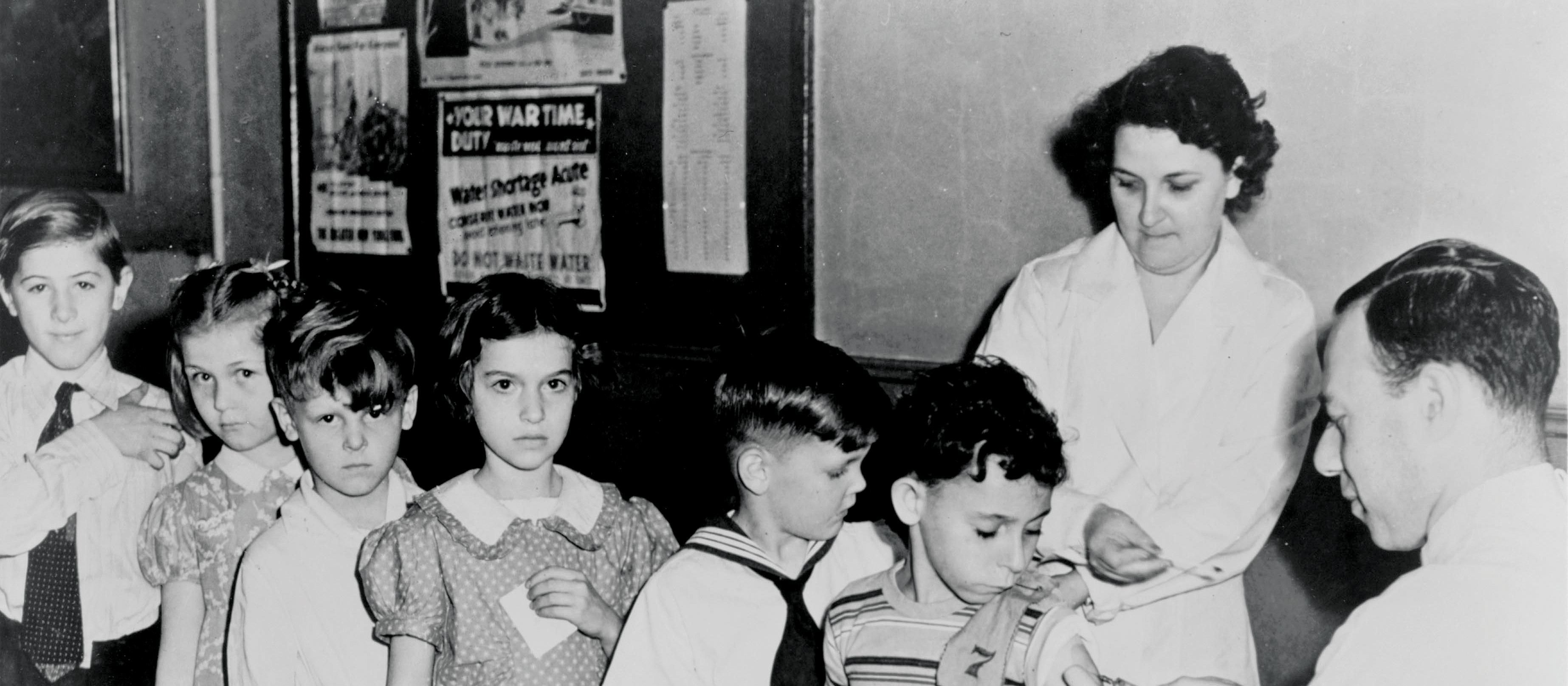 School children line for vaccination