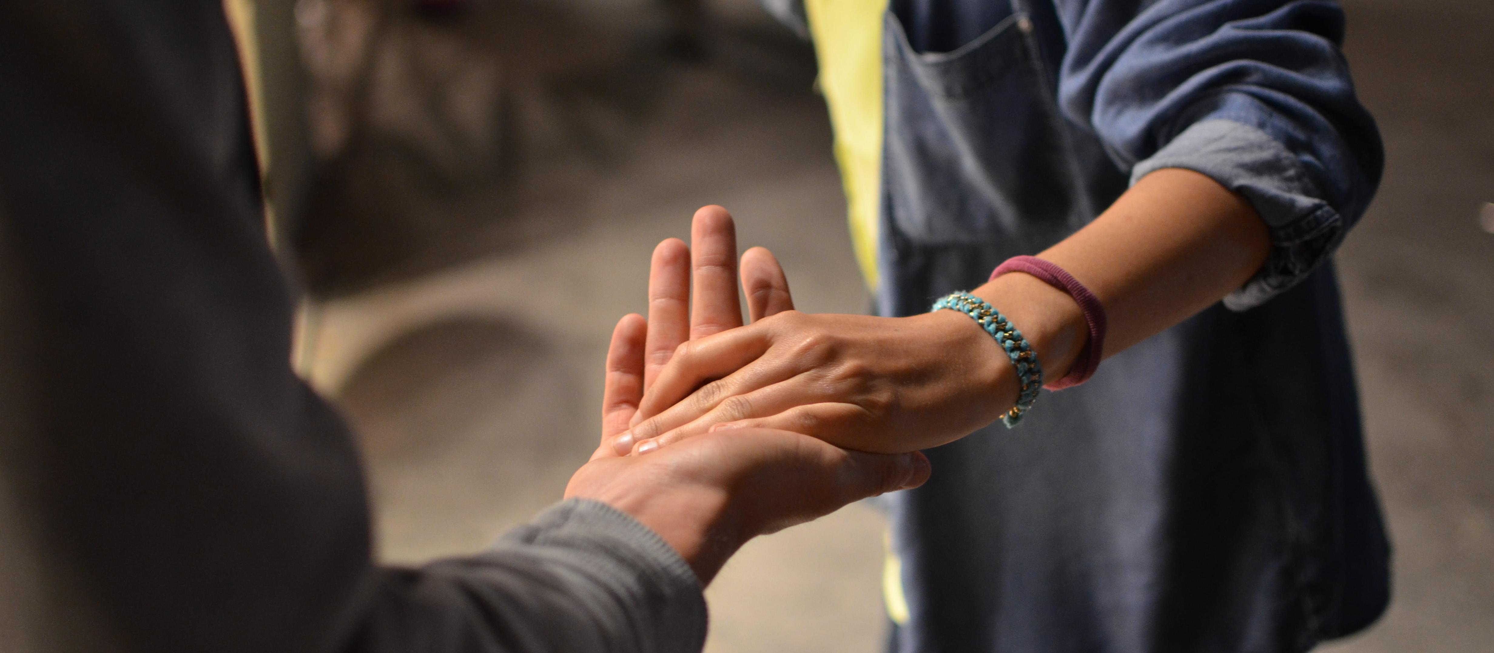 Compassion, holding hands. Photo by Remi Walle on Unsplash