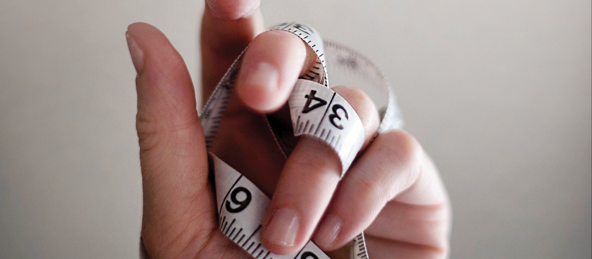 Hand and measuring tape