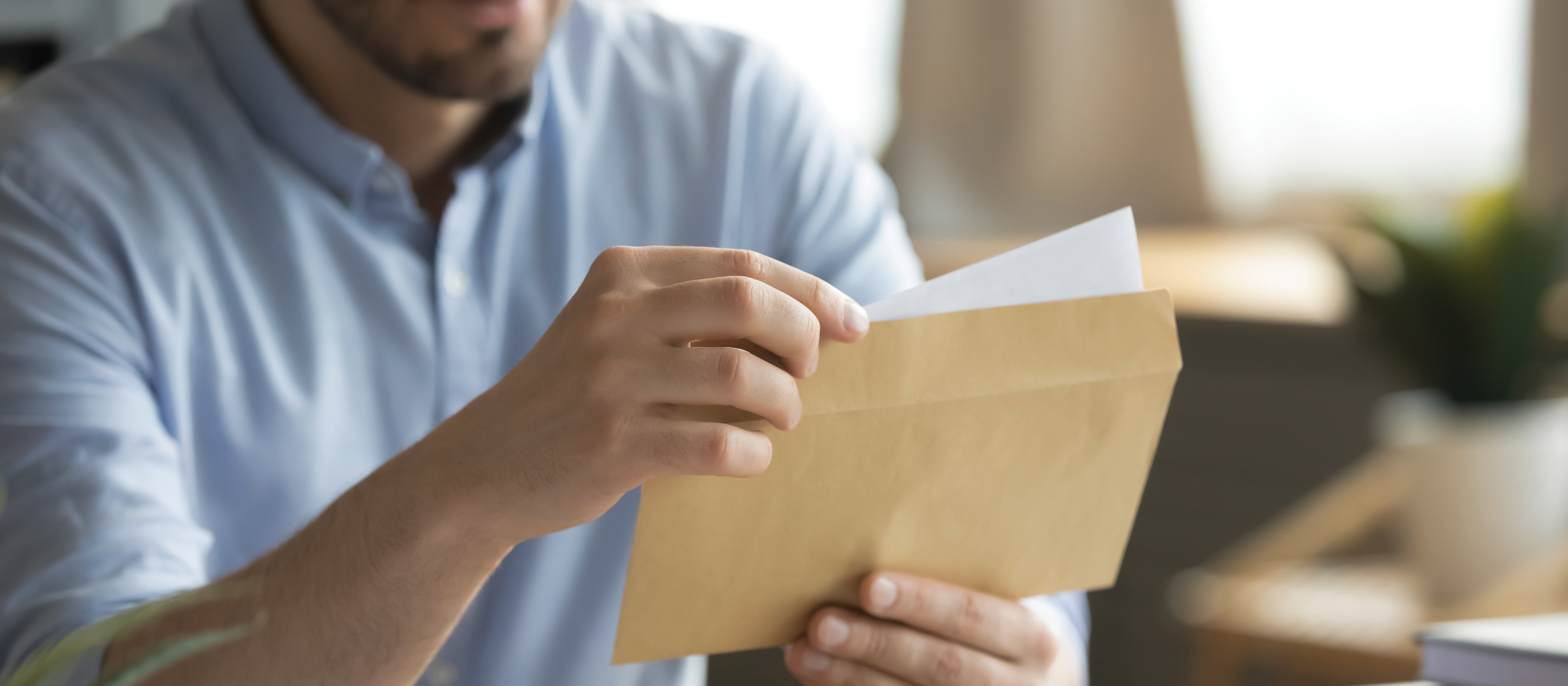 Man opening Letter CR fizkes on iStock