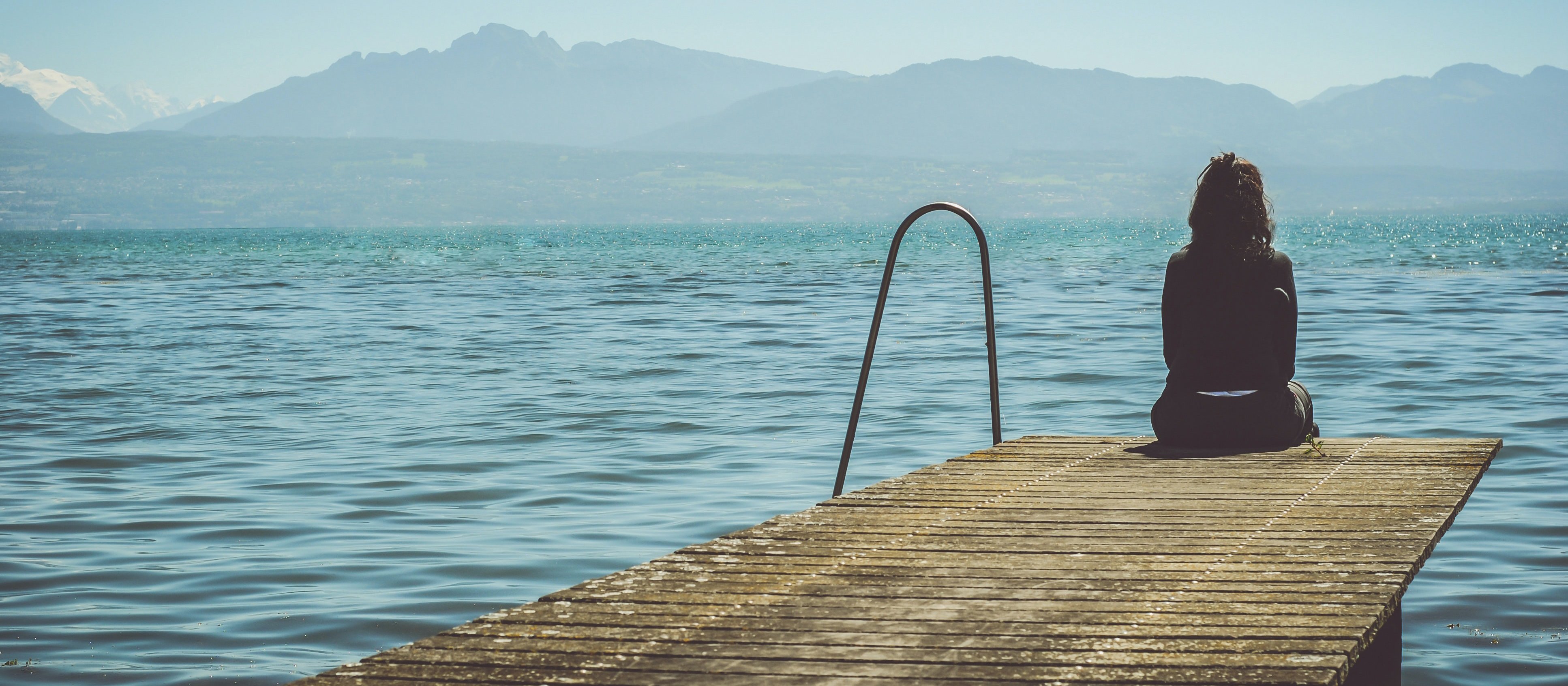 Woman_on_pier_Lake_CR_Paola_Chaaya_on_Unsplash.jpg