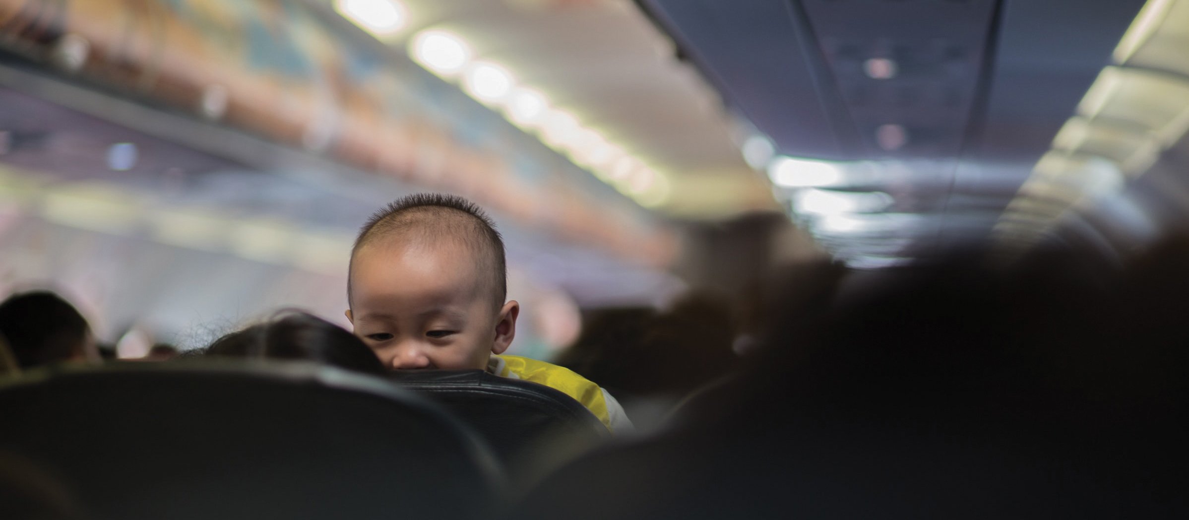 Baby on plane CR Octav-cado on Unsplash