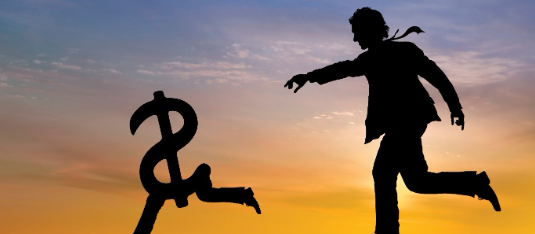 Man chasing dollar sign