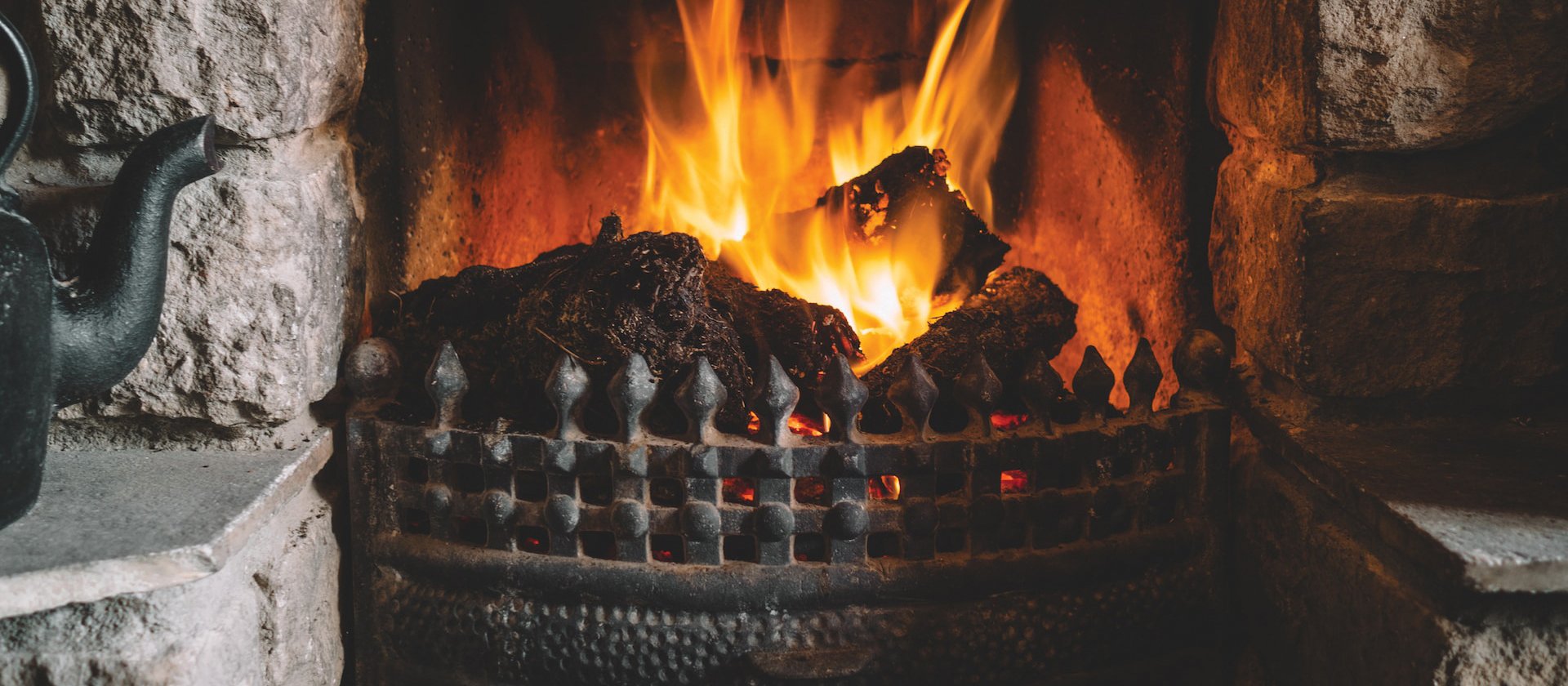 Fireplace stone lit CR Andrew Ridley on Unsplash