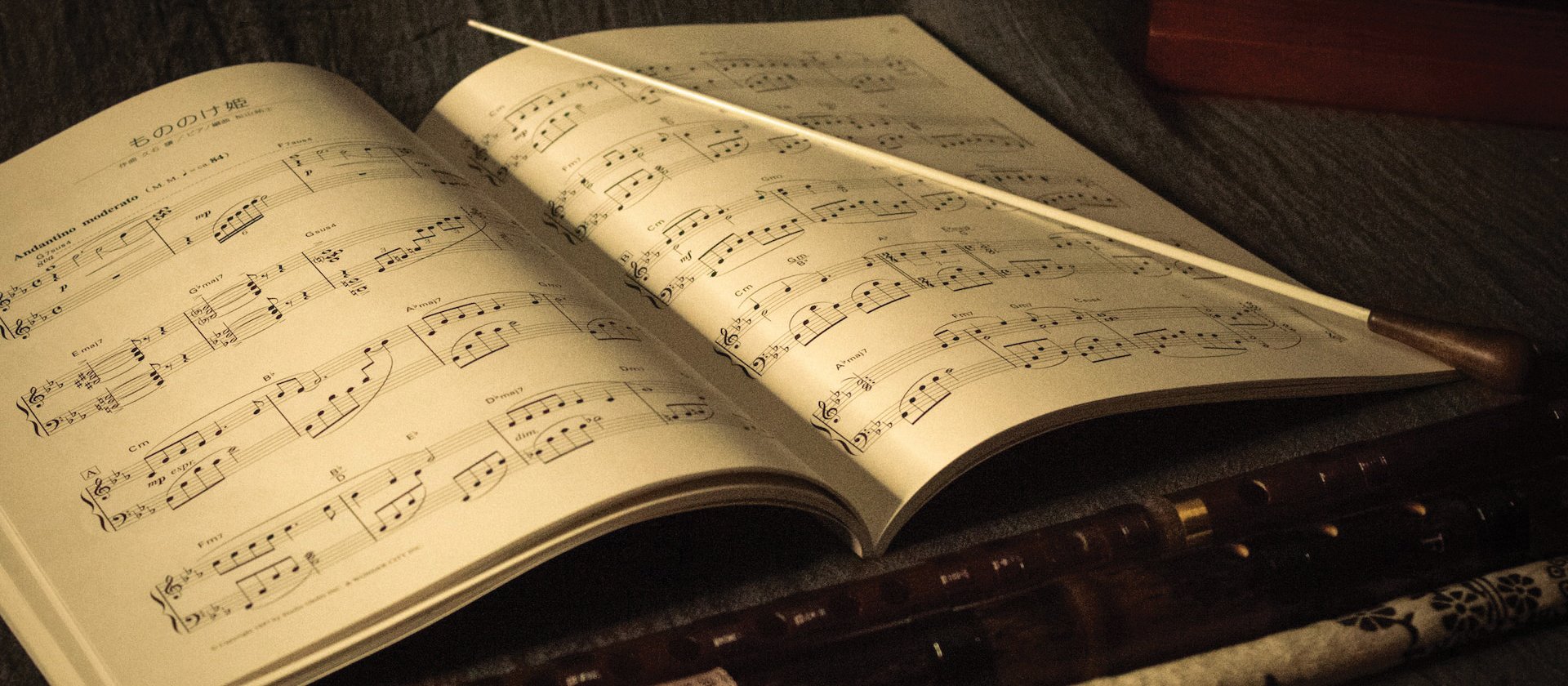 music sheet and baton CR Joshua Chehov on Unsplash