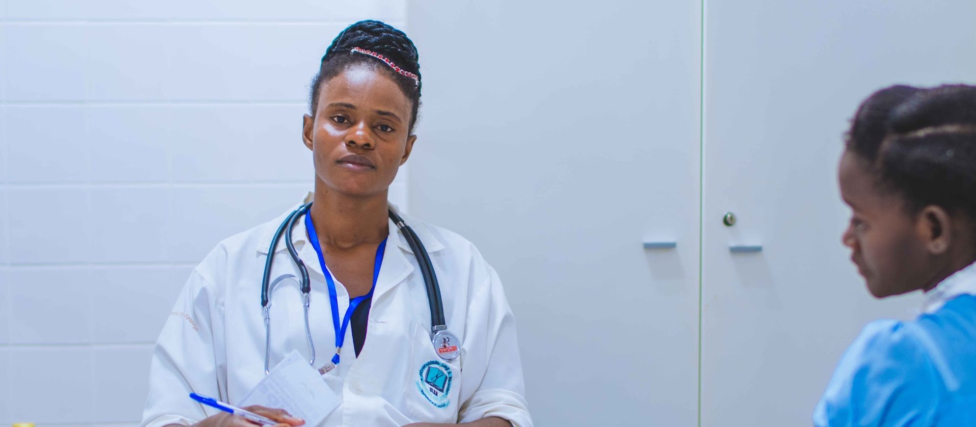 Black female doctor with patient