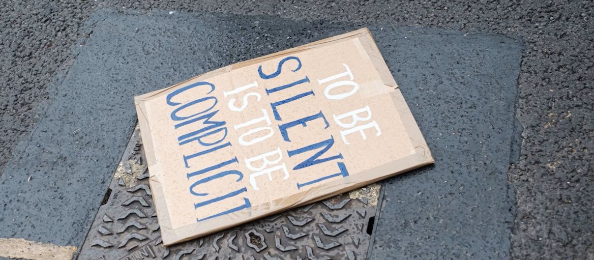 Silence complicit sign 