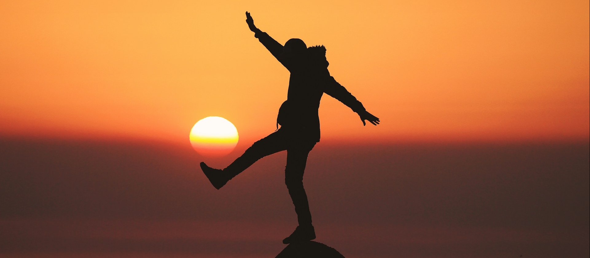 Silhouette man balancing on rock CR Aziz Acharki on Unsplash