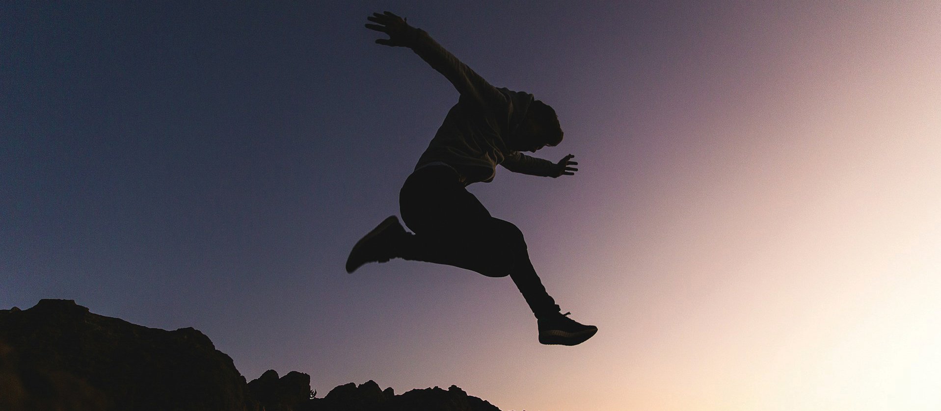 Person leaping CR Joshua Earle on Unsplash