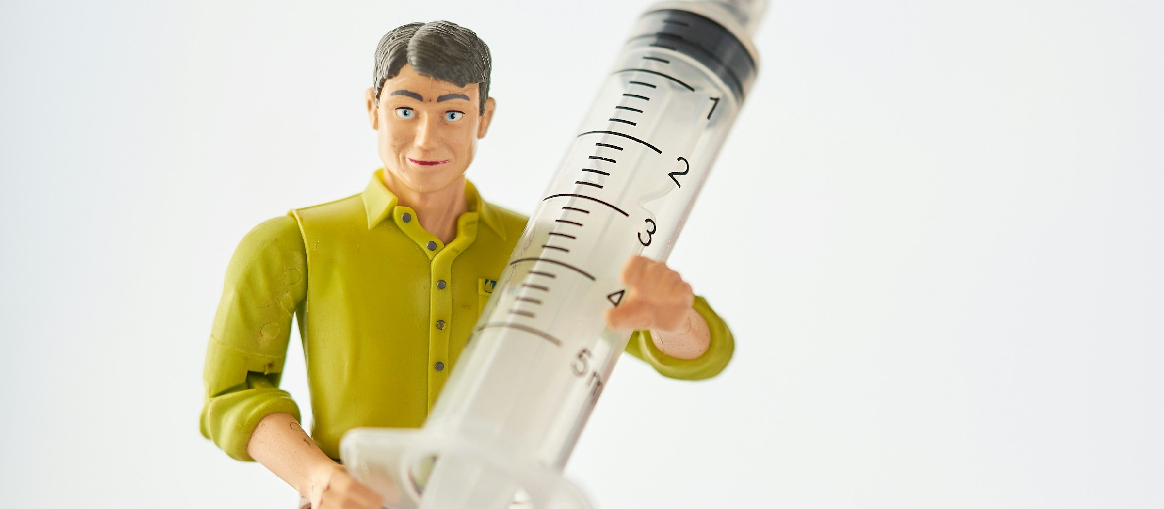 Toy man holding a syringe