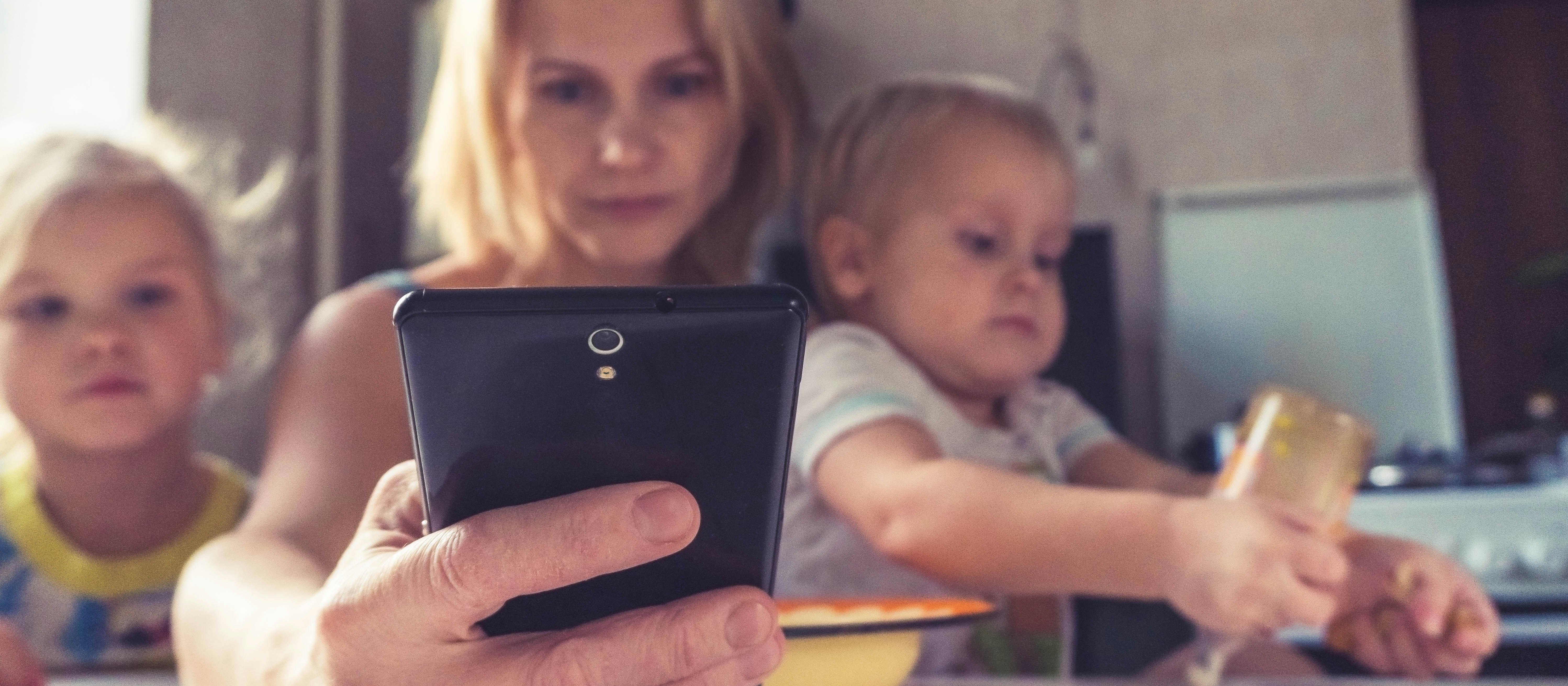 Woman, phone, kids [Vitolda Klein on Unsplash]