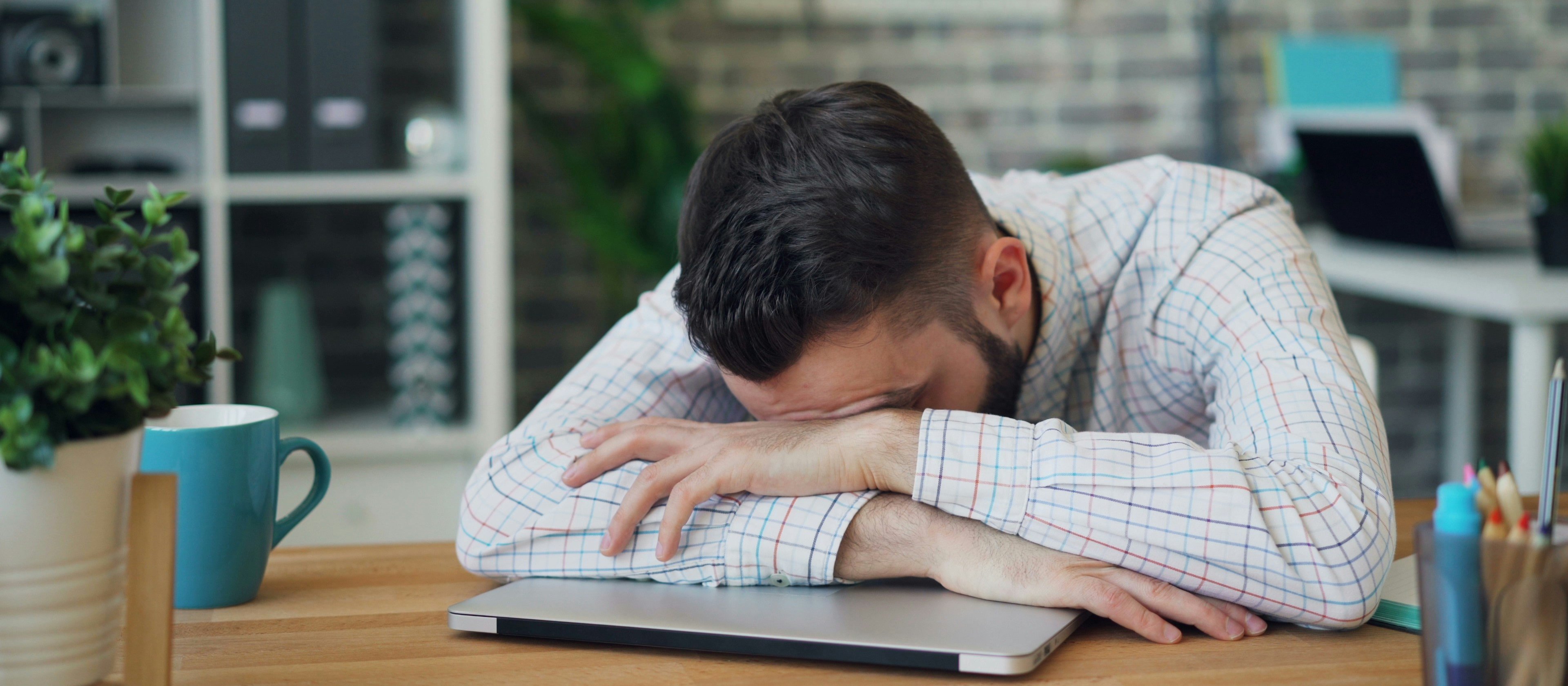 Man resting on laptop CR Vitaly Gariev on Unsplash