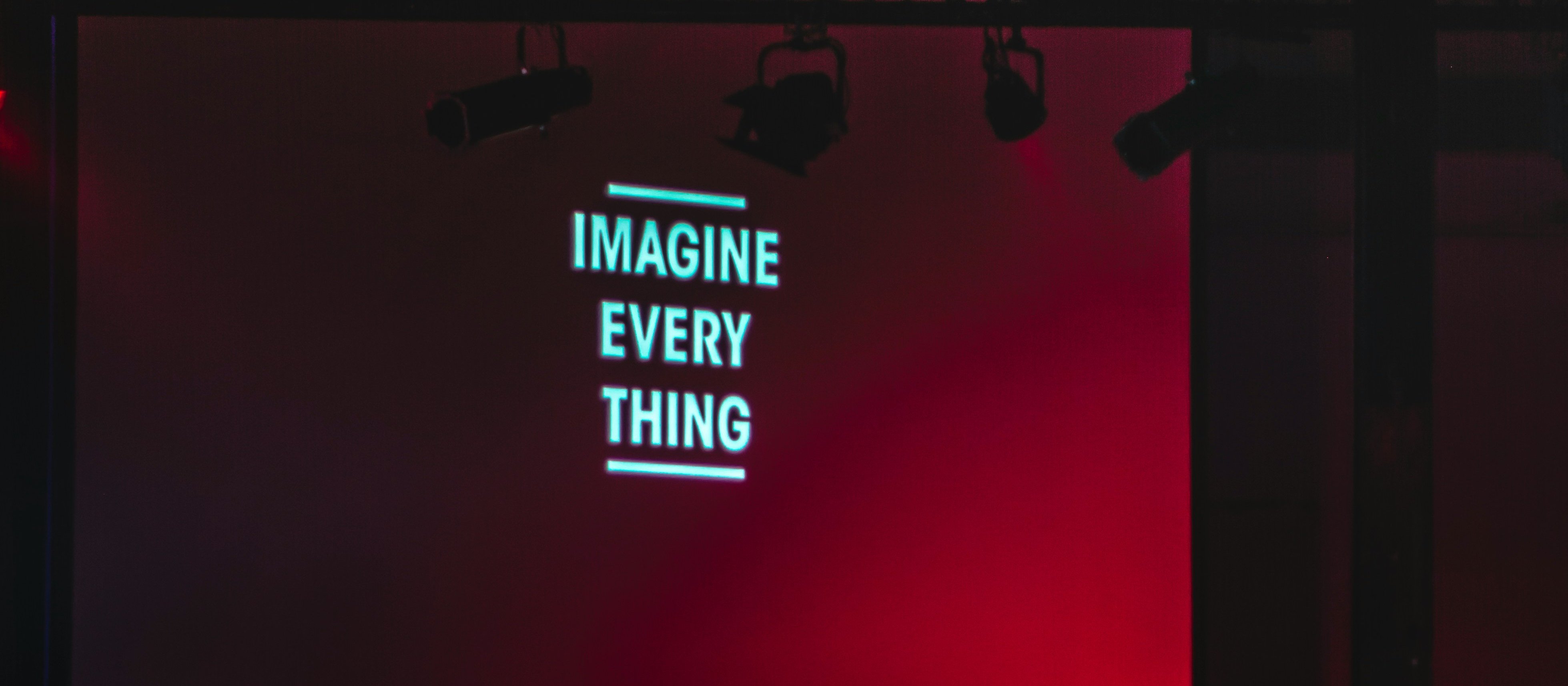 Black monitor displaying Imagine Every Thing CR Alexandre Debieve