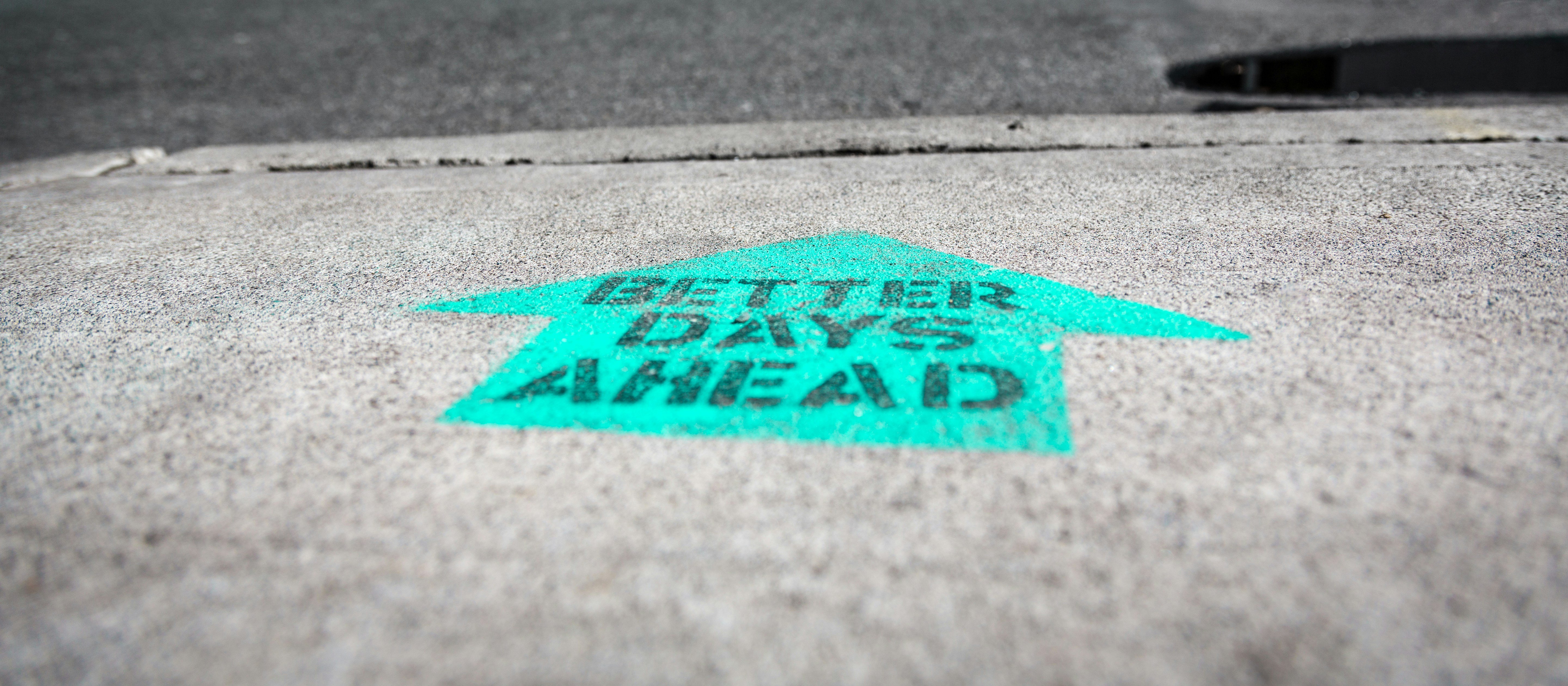 Better days, arrow on road, concrete