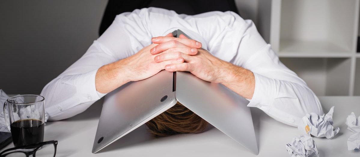Man laptop over head despair CR iStock