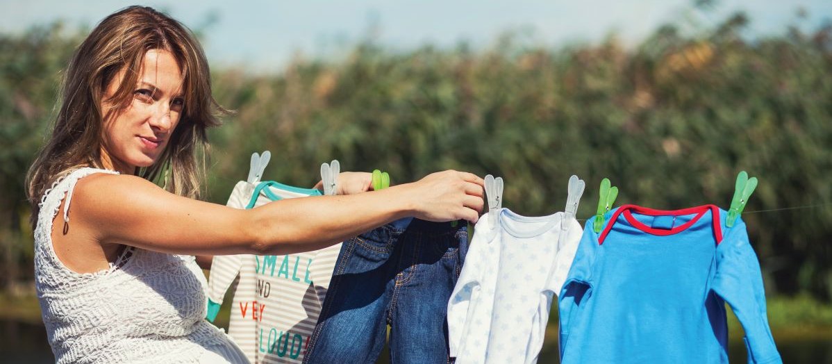 Pregnant woman hanging out washing