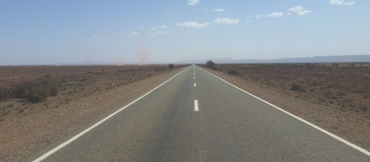 Open road, desert, dust tornados