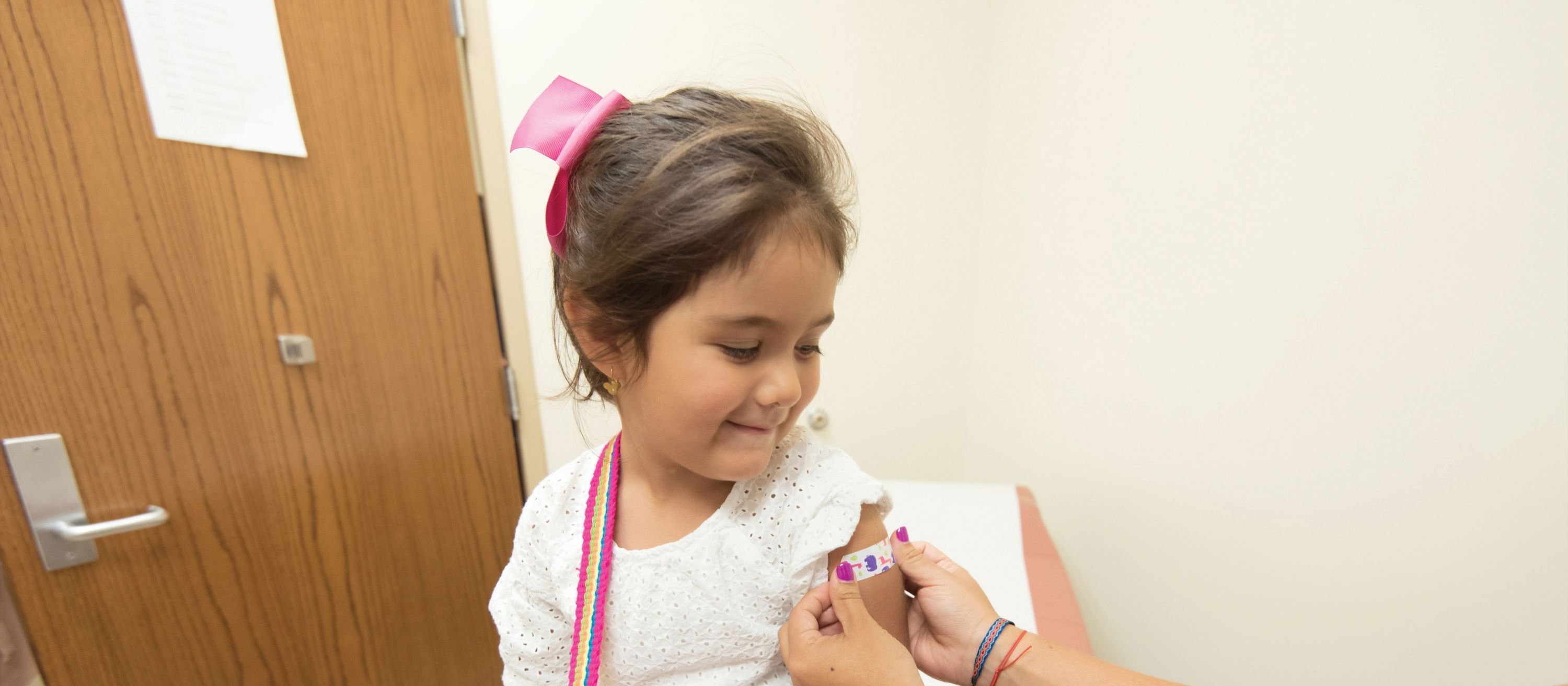 Girl vaccine bandaid CR CDC on Unsplash
