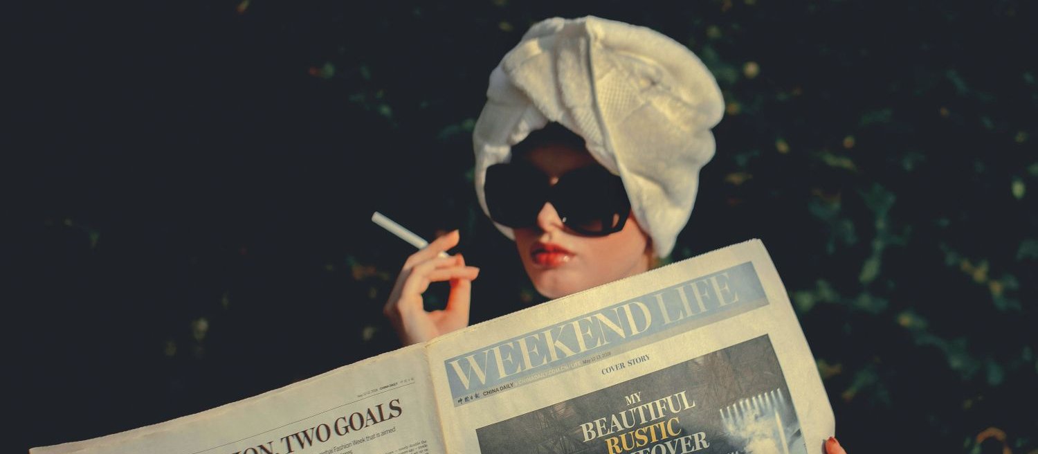 Woman Smoking w Newspaper CR igor rand dUSKN2DgBG4 on unsplash