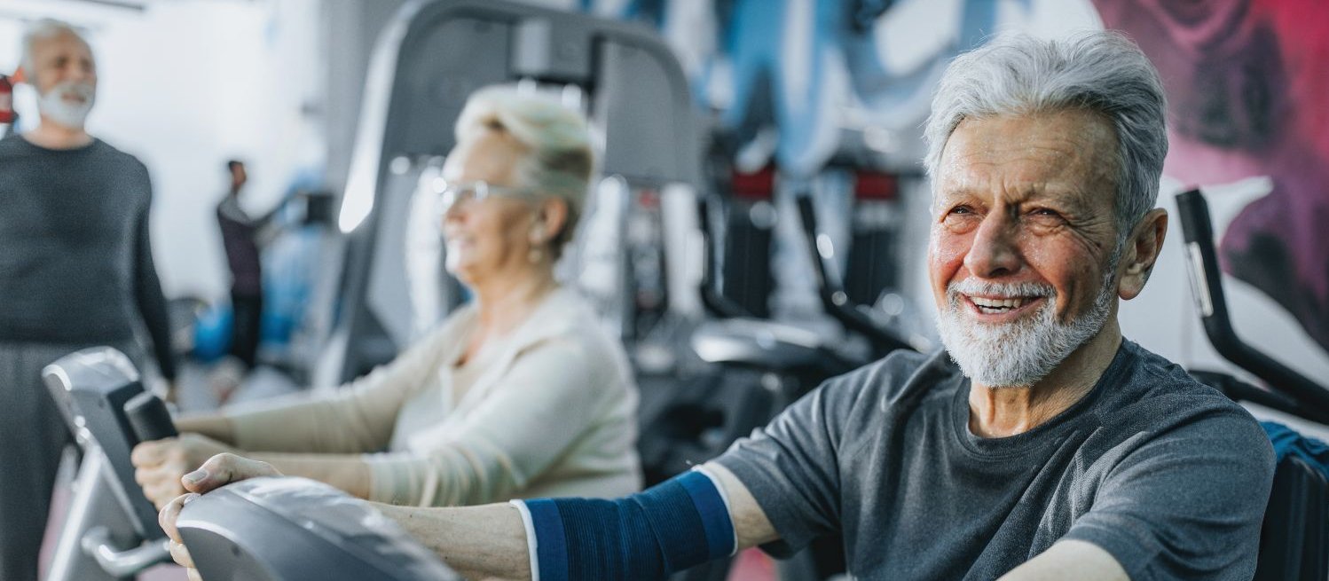 Older man exercising, exercise bike, elder health