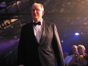 Adrian Tucker walking to the stage