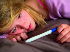 Teenage girl with a pregnancy test