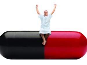 Man sitting on a pill_iStock