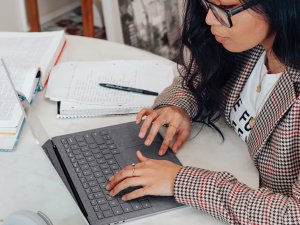 Young woman on laptop_Surface on Unsplash
