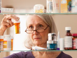 Woman looking at pills 