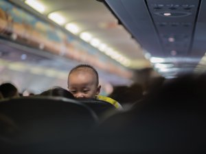 Baby on plane CR Octav-cado on Unsplash