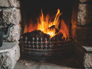 Fireplace stone lit CR Andrew Ridley on Unsplash