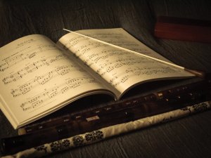 music sheet and baton CR Joshua Chehov on Unsplash