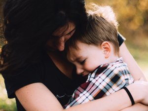 Woman hugs child CR Jordan Whitt on Unsplash