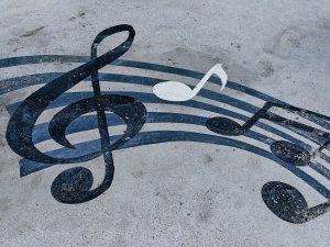 Music notes on sand CR Tengyart on Unsplash