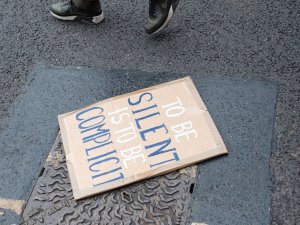 Silence complicit sign 