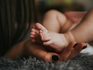 Baby feet adult hand