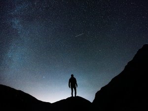 Starry night and man CR Joshua Earle on Unsplash