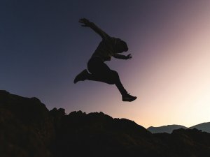 Person leaping CR Joshua Earle on Unsplash