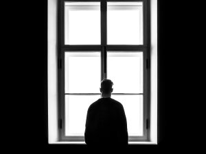 Man at Window CR Sasha Freemind on Unsplash