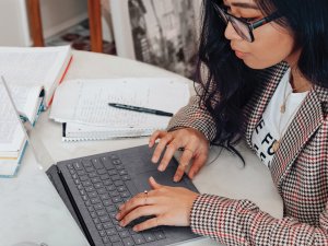 Young woman laptop CR Surface on Unsplash