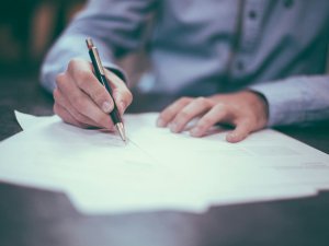 Hands writing pen CR Scott Graham on Unsplash